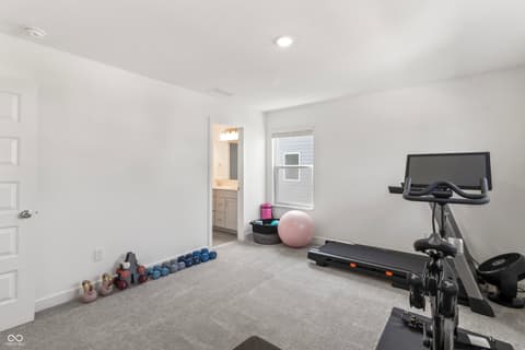 Bonus room at 1438 Chatham Hills Boulevard, Westfield, IN — Dedicated home gym with ensuite bathroom access.