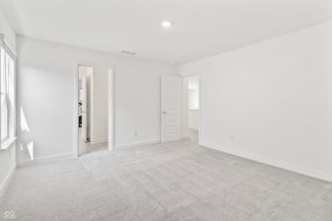 Primary bedroom at 1438 Chatham Hills Boulevard, Westfield, IN — Spacious primary bedroom with ensuite and walk-in closet.