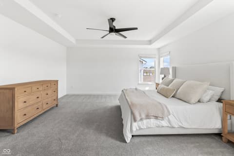 Primary bedroom at 1438 Chatham Hills Boulevard, Westfield, IN — Spacious primary suite with tray ceiling and balcony access.
