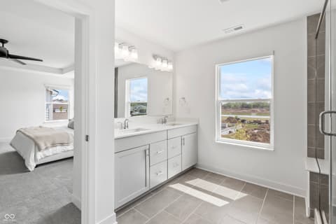 Primary bathroom at 1438 Chatham Hills Boulevard, Westfield, IN — Bright primary bath with dual vanity and scenic views.