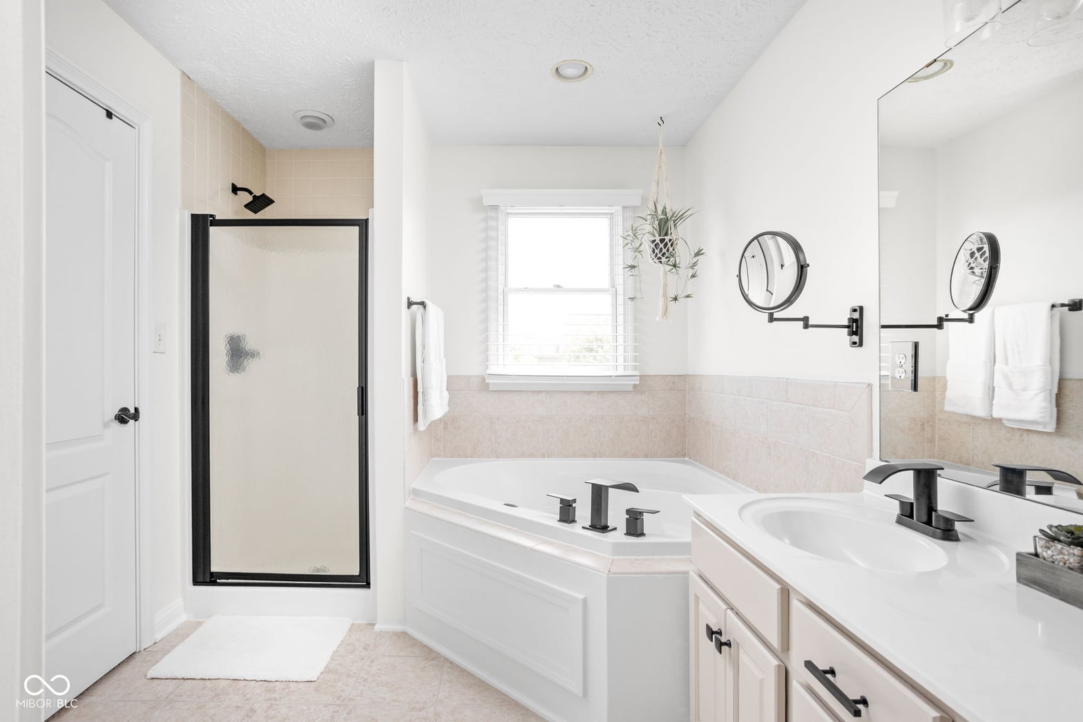 Primary bathroom at 2025 W Morse Drive, Cicero, IN — Luxurious primary bath with dual vanity and soaking tub.