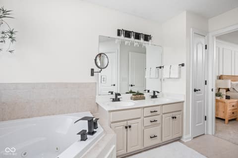 Primary bathroom at 2025 W Morse Drive, Cicero, IN — Luxurious primary bath with dual vanity and soaking tub.