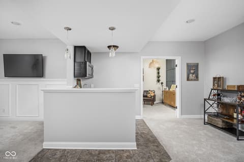 Basement at 2025 W Morse Drive, Cicero, IN — Finished basement with modern wet bar and open layout.