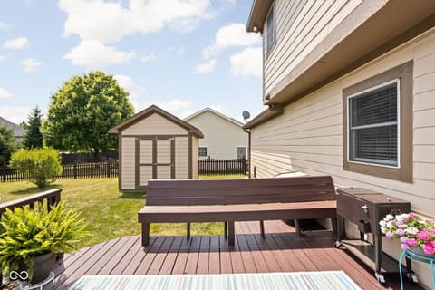 Backyard at 2025 W Morse Drive, Cicero, IN — Spacious backyard deck with storage and mature landscaping.