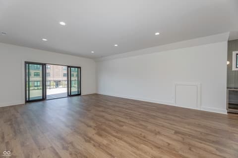 Living room at 8694 Morgan Drive, Fishers, IN — Bright contemporary living space with balcony access.