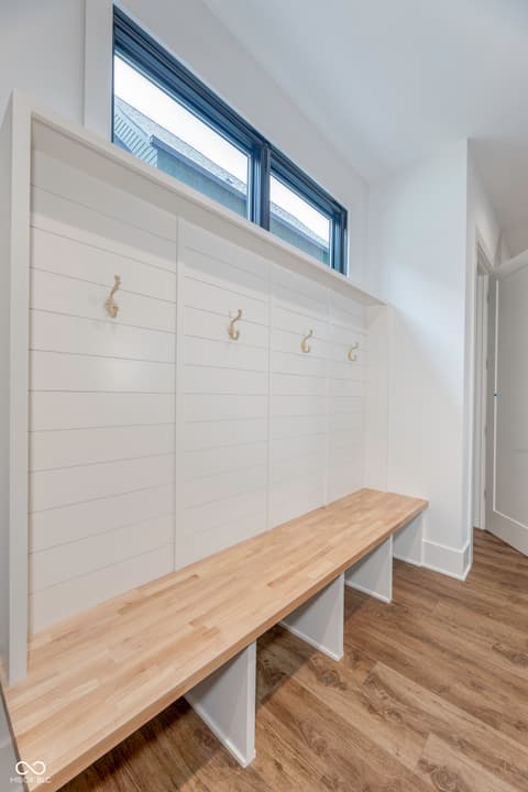 Foyer at 8694 Morgan Drive, Fishers, IN — Bright mudroom with custom built-in storage and seating.