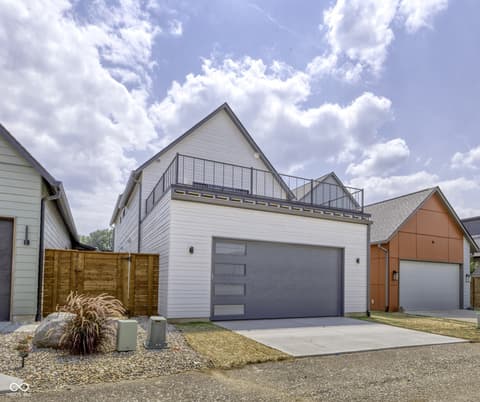 Front exterior at 8694 Morgan Drive, Fishers, IN — Modern home with rooftop deck and sleek garage