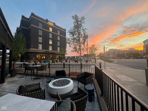 Outdoor living area at 8694 Morgan Drive, Fishers, IN — Stunning rooftop terrace with fire pit and city views.
