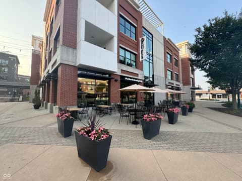 Front exterior at 8694 Morgan Drive, Fishers, IN — Modern mixed-use building with vibrant street-level patio.