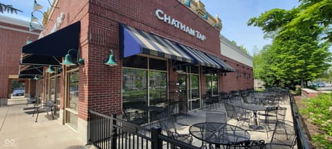 Front exterior at 8694 Morgan Drive, Fishers, IN — Charming brick storefront with inviting outdoor patio space.