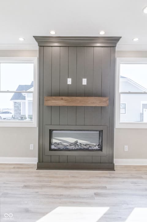 Living room at 14890 E Keenan Circle, Westfield, IN — Statement fireplace wall with shiplap and wood mantel.