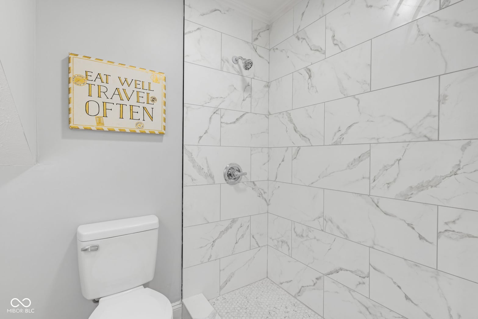Luxe marble shower with elegant subway tile design.