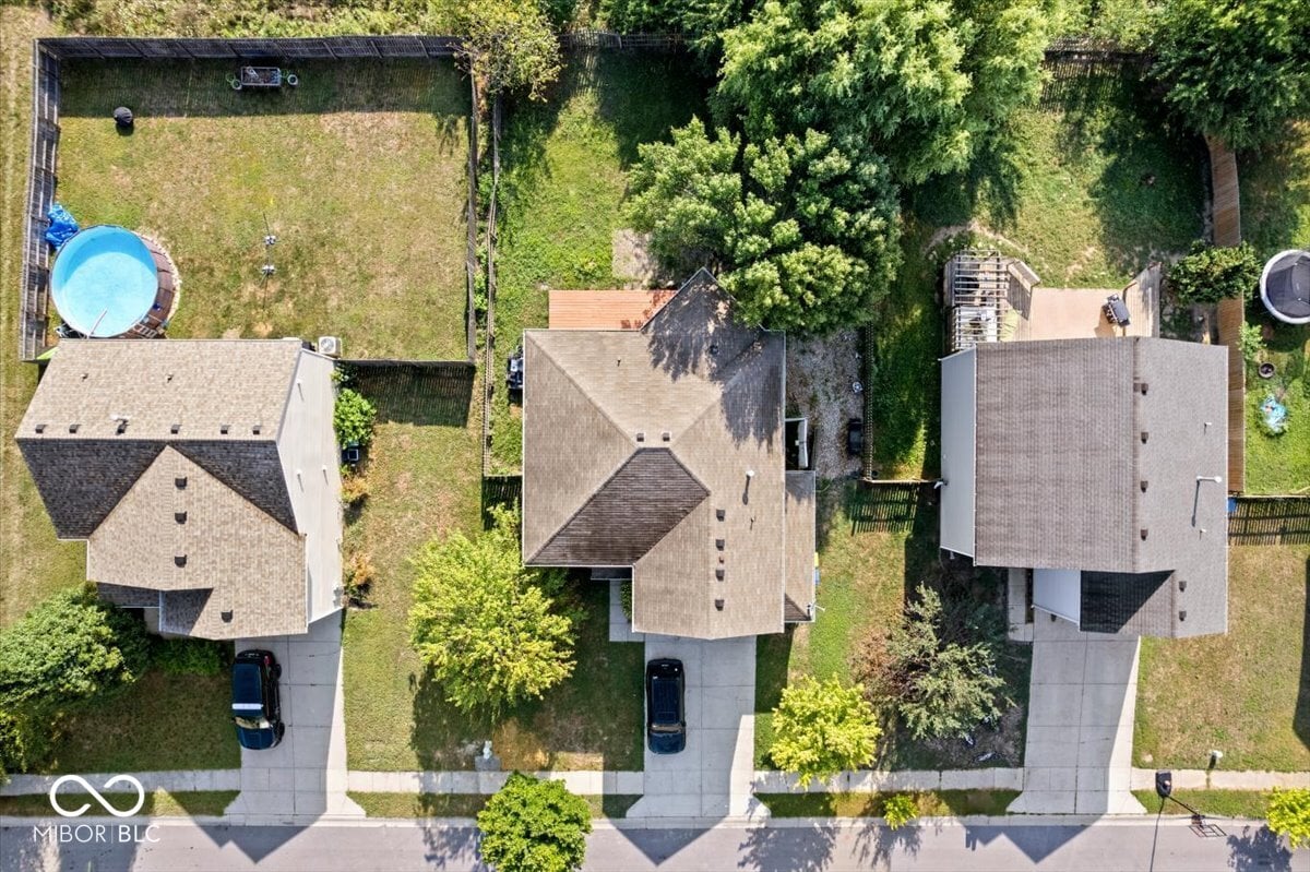 Aerial view shows homes with pools and mature landscaping.