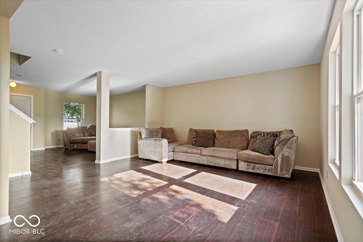 Spacious family room with hardwood floors and natural light.