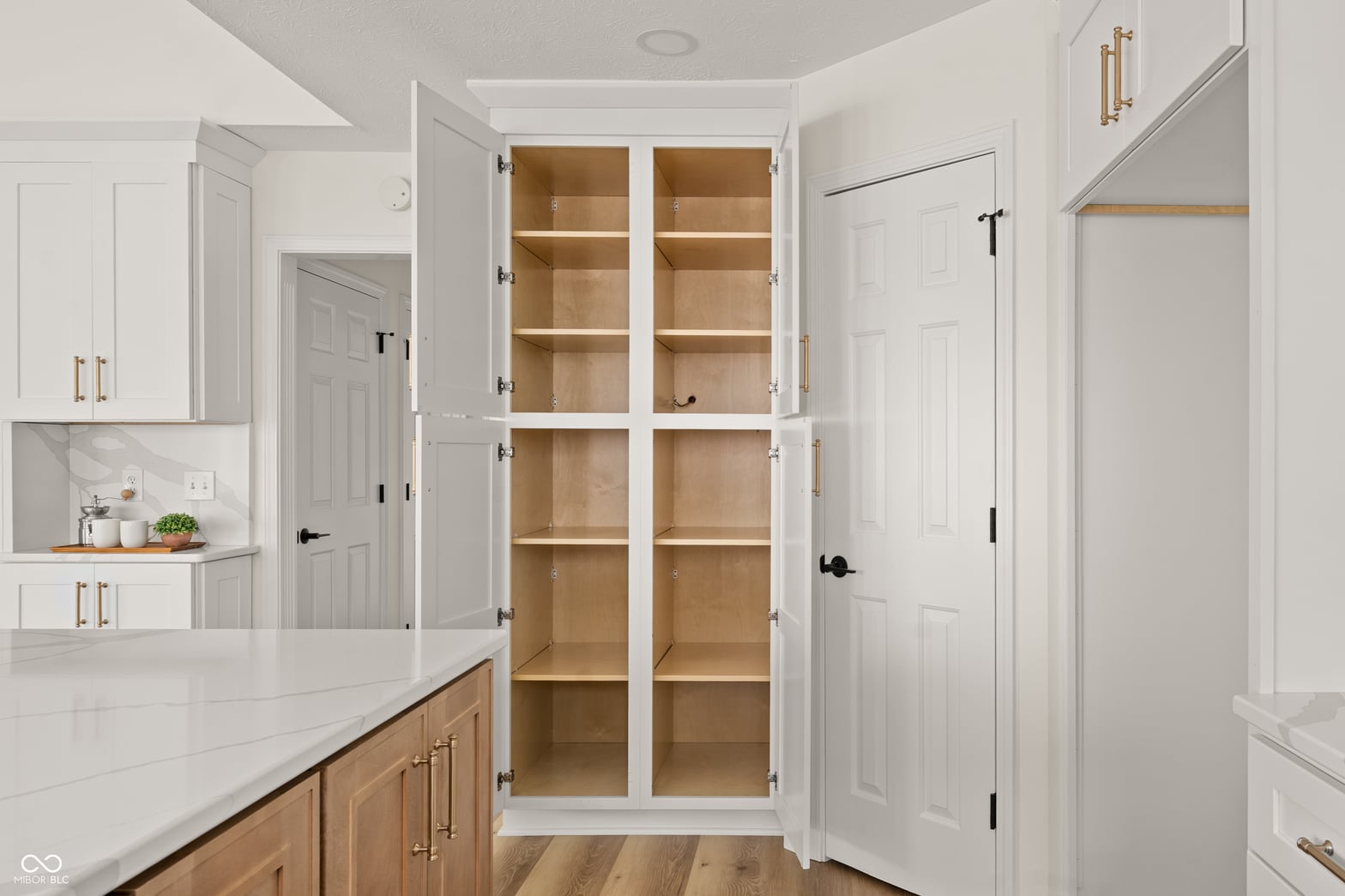 Luxury primary bathroom with custom walk-in closet storage.