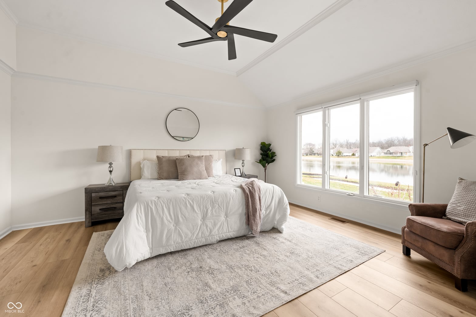 Spacious primary bedroom with waterfront views and modern finishes.