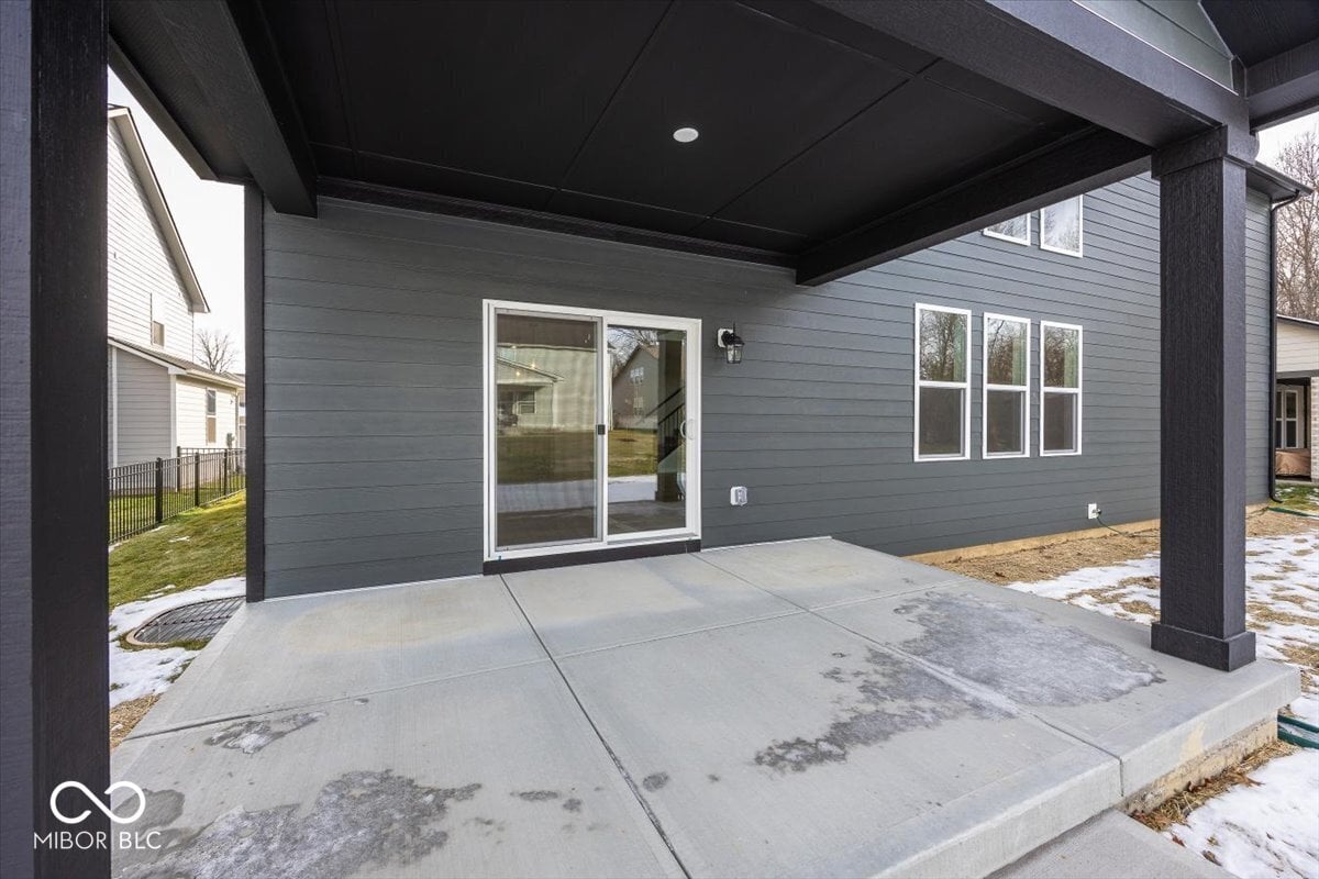 Spacious covered patio with modern finishes and access.