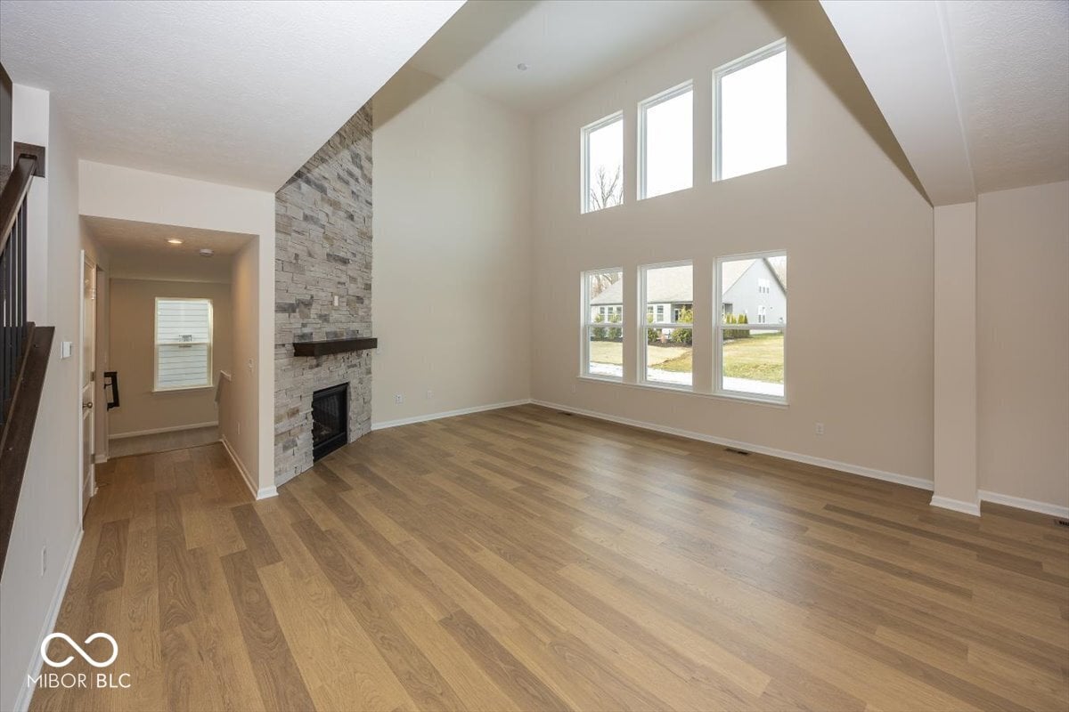 Bright family room with stone fireplace and vaulted ceilings.