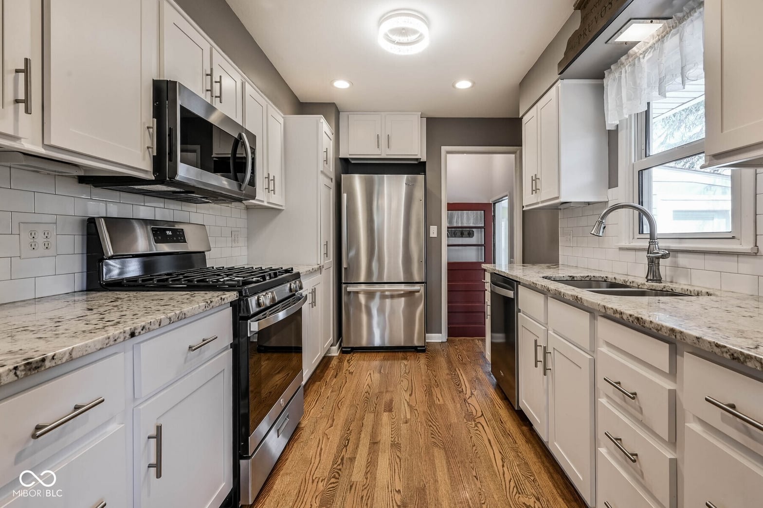 Modern renovated kitchen with granite and stainless steel.