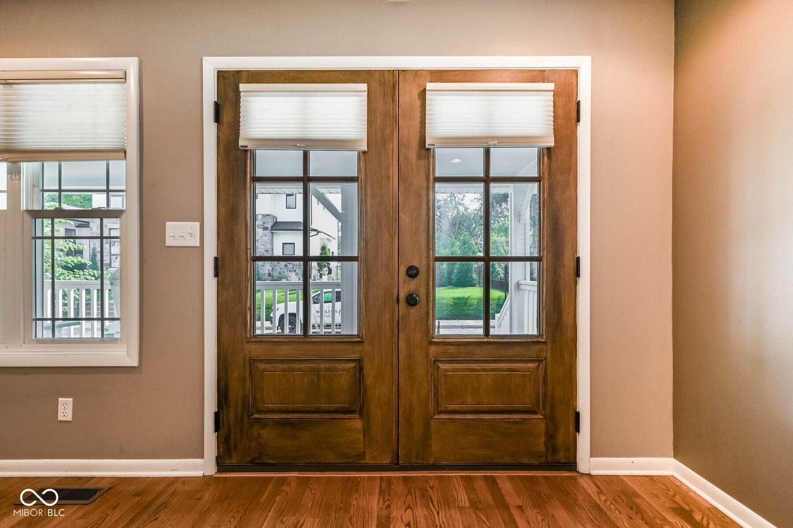 Elegant french doors with natural light and hardwood floors.