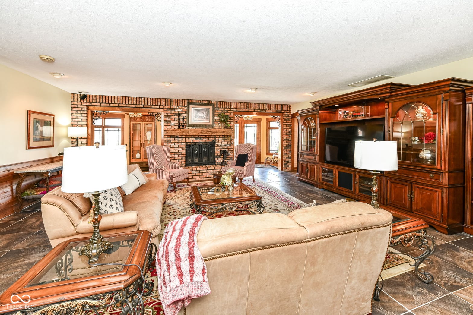 Elegant traditional living room with impressive brick fireplace.