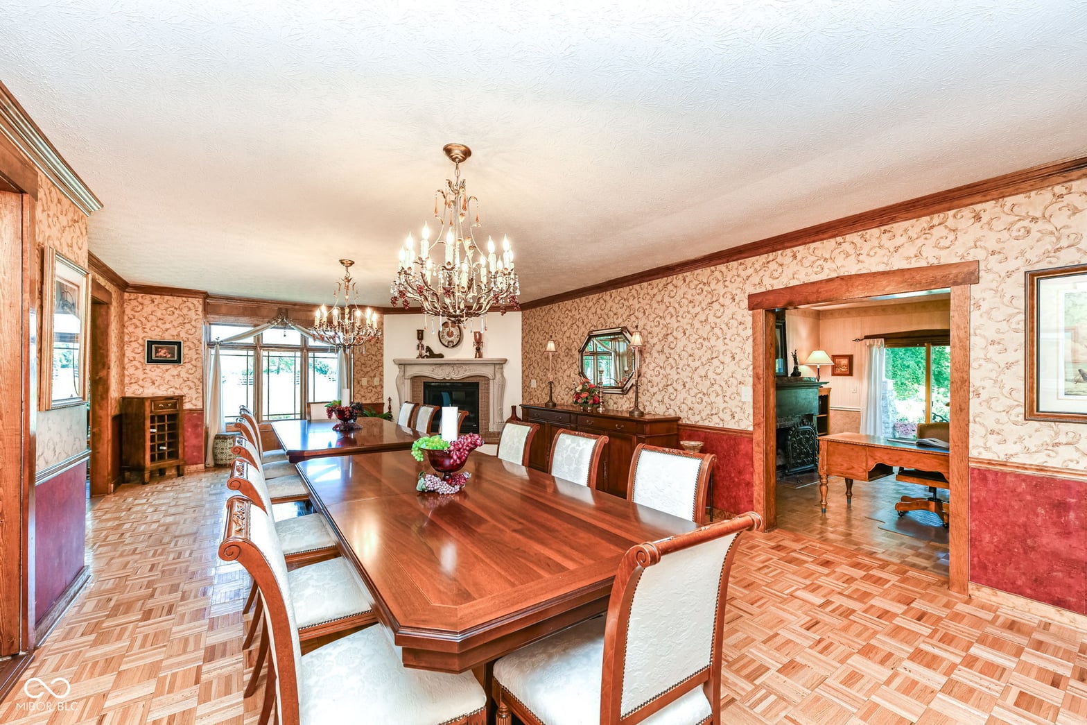 Elegant formal dining room with fireplace and crystal chandeliers.