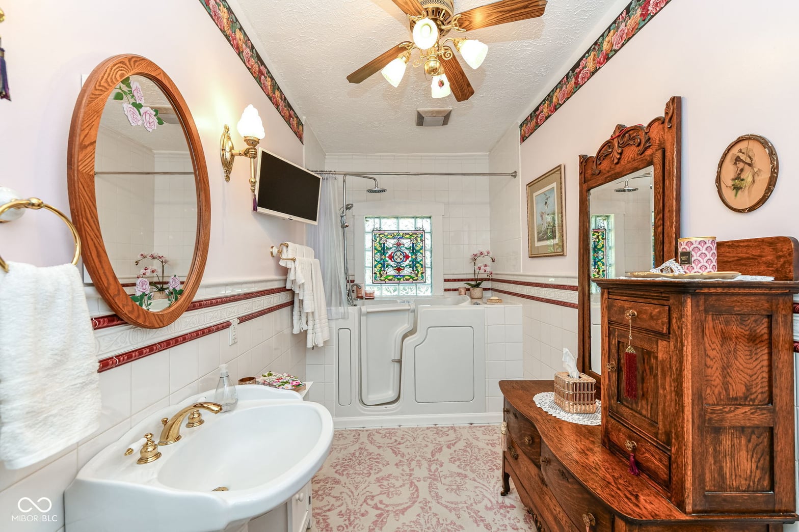 Elegant primary bath with walk-in shower and period details.