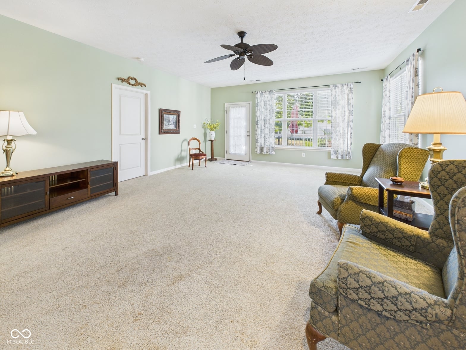 Spacious living room with abundant natural light and french doors.