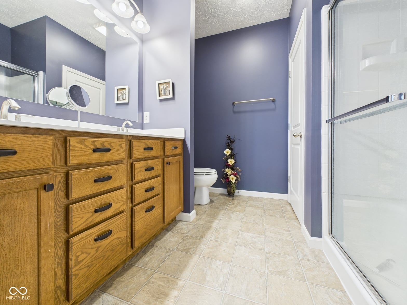 Spacious primary bath with double vanity and walk-in shower.