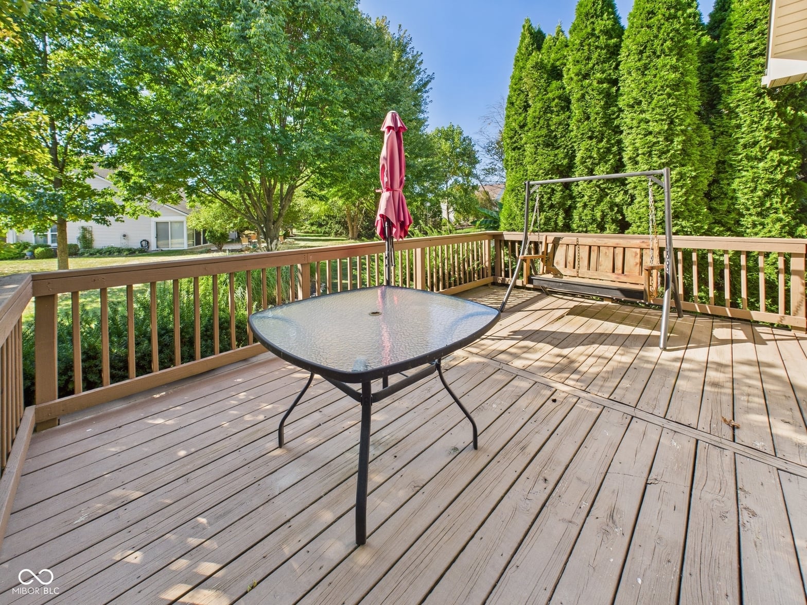 Spacious composite deck with mature landscaping and privacy.