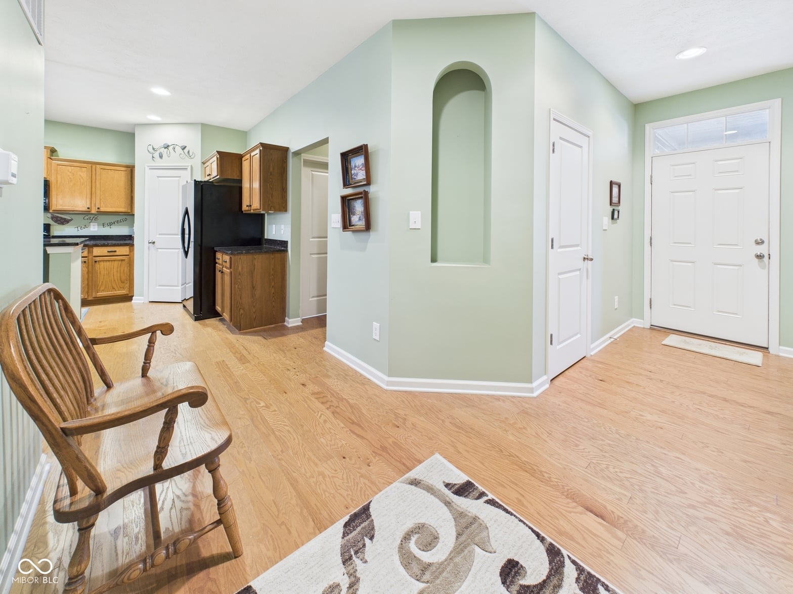 Bright updated kitchen with hardwood floors and sage accents.