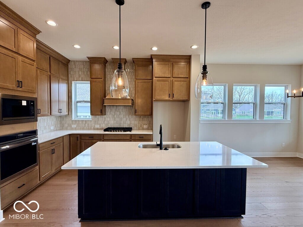 Modern kitchen with large island and abundant natural light.