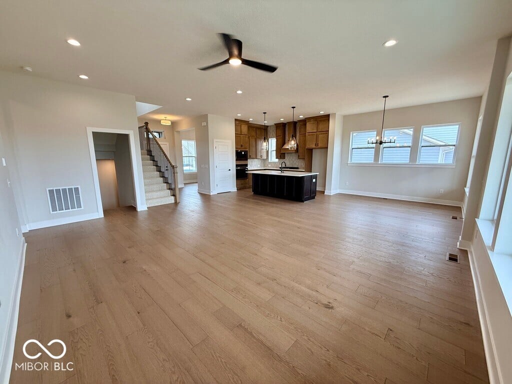 Bright open-concept living space with premium hardwood flooring.