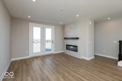 Living room at 406 Elite Street, Westfield, IN — Modern living space with waterfront views and fireplace.