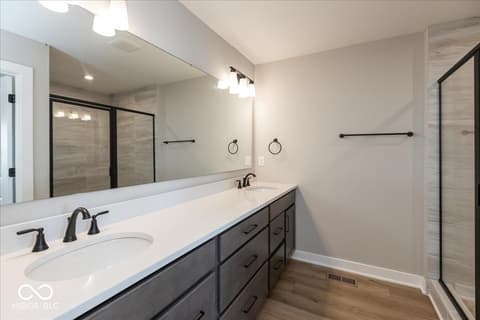 Primary bathroom at 406 Elite Street, Westfield, IN — Spa-like primary bath with dual vanity and walk-in shower.