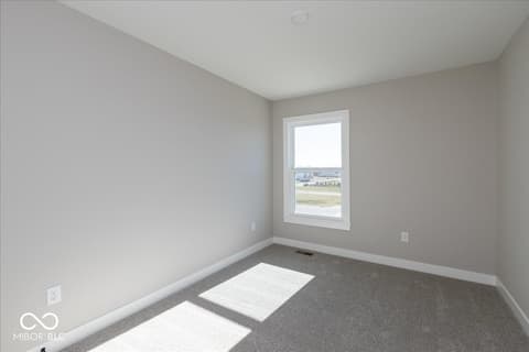 Bedroom at 406 Elite Street, Westfield, IN — Bright bedroom with expansive window and scenic views.