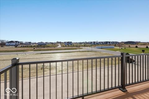 Backyard at 406 Elite Street, Westfield, IN — New home with expansive deck overlooking open development.