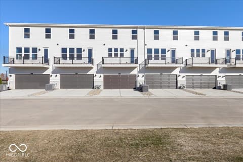 Front exterior at 406 Elite Street, Westfield, IN — Brand new contemporary townhomes with garages and balconies.