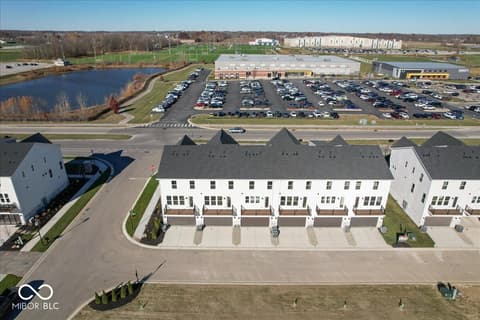 Front exterior at 406 Elite Street, Westfield, IN — Modern townhome community with pond and walking trails.
