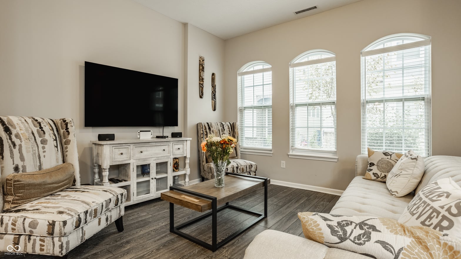 Bright living room with arched windows and updated finishes.
