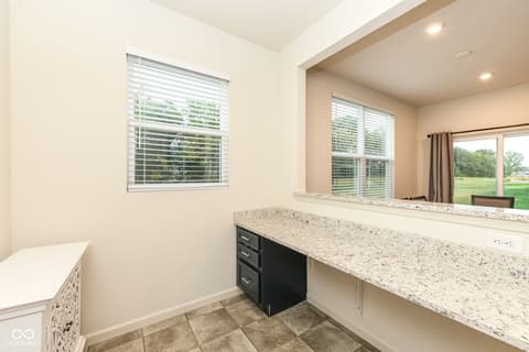 Primary bathroom at 15104 Downham Drive, Fishers, IN — Luxurious spa-like primary bath with dual vanity.