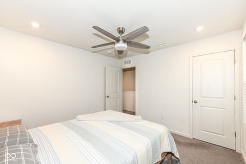 Bedroom at 15104 Downham Drive, Fishers, IN — Bright, spacious bedroom with modern ceiling fan and closet.