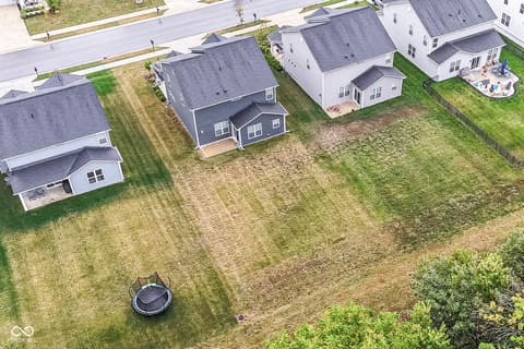 Aerial view at 15104 Downham Drive, Fishers, IN — Spacious lot with large fenced yard and trampoline.