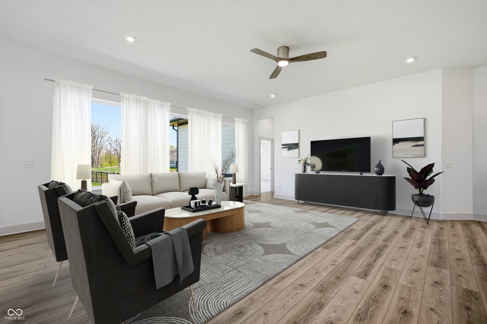 Bright, open living room with floor-to-ceiling windows.