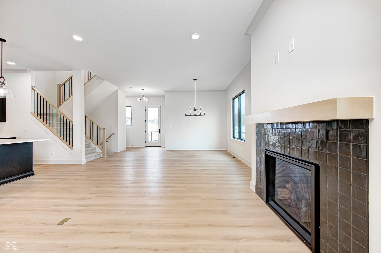 Bright open concept with fireplace and hardwood throughout.