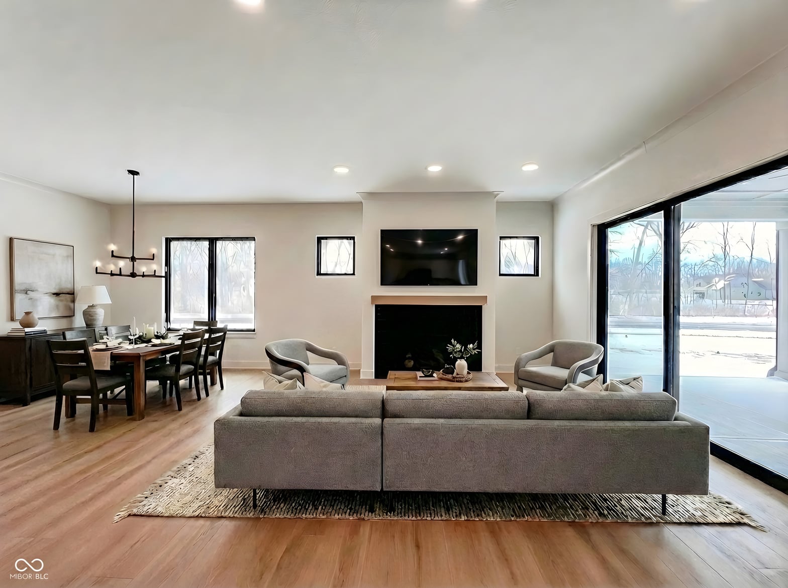 Spacious open-concept living room with fireplace and modern finishes.