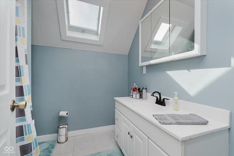 Primary bathroom at 140 Wiley Street, Cicero, IN — Bright bathroom with skylights and updated finishes.