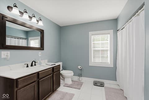 Primary bathroom at 140 Wiley Street, Cicero, IN — Updated primary bath with dual vanity and soft blue walls.