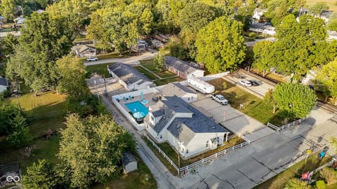 Aerial view at 140 Wiley Street, Cicero, IN — Modern home with resort-style pool and mature trees.