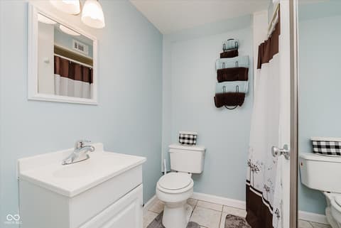 Bathroom at 140 Wiley Street, Cicero, IN — Clean, organized bathroom with fresh light blue accents.